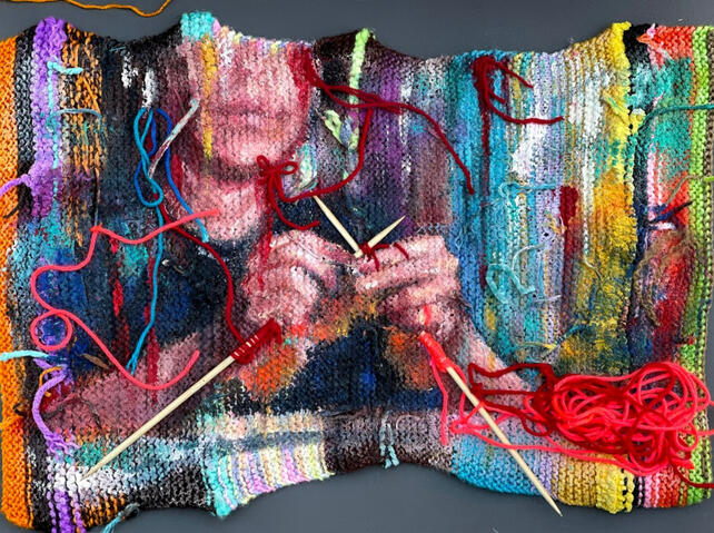 Multimedia artwork showing the bottom of someones face and their hands knitting, painted in oil paint on a piece of knitted fabric, with real knitting needles emerging from the fabric.